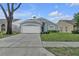 Single-story home with a two-car garage, well-maintained front yard and a welcoming facade at 1808 Westpointe Cir, Orlando, FL 32835