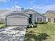 Inviting single-story home with a two-car garage and manicured front yard at 1808 Westpointe Cir, Orlando, FL 32835