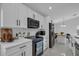 Modern kitchen featuring white cabinetry and stainless steel appliances at 1808 Westpointe Cir, Orlando, FL 32835