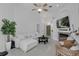 Spacious living room with white sofa, modern fireplace, TV, and view of the front door at 1808 Westpointe Cir, Orlando, FL 32835