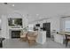 Bright, open-concept living and kitchen area with fireplace, TV, modern appliances, and wicker chairs at 1808 Westpointe Cir, Orlando, FL 32835
