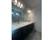 This bathroom features a double vanity with quartz countertop, large mirror and tile floors at 2064 Asher Ave, Minneola, FL 34715