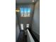 Bright entryway with stairs, tiled floor, and large windows providing natural light and neighborhood views at 2064 Asher Ave, Minneola, FL 34715