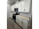 Well-equipped kitchen with stainless steel appliances, sleek white cabinets, and modern countertops at 2064 Asher Ave, Minneola, FL 34715