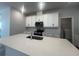 Modern kitchen featuring white cabinets, stainless steel appliances, and a large center island with sink at 2064 Asher Ave, Minneola, FL 34715