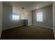 Upstairs loft area with neutral carpet, a window for natural light, and a view of the neighborhood at 2064 Asher Ave, Minneola, FL 34715