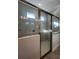 Modern tiled shower with glass door, rainfall shower head, and built-in shower caddy at 2064 Asher Ave, Minneola, FL 34715