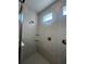 Modern shower featuring neutral tile with rainfall shower head and built-in corner shelves at 2064 Asher Ave, Minneola, FL 34715