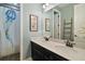 Well-lit bathroom features double sinks, a large mirror, and shower with unique jellyfish shower curtain at 2136 Lula Rd, Minneola, FL 34715