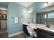 Modern bathroom with double vanity sinks, sleek hardware, and access to a closet at 2136 Lula Rd, Minneola, FL 34715