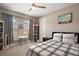 Comfortable bedroom featuring a plaid comforter, arched windows, and natural lighting at 2136 Lula Rd, Minneola, FL 34715