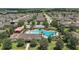 Aerial shot of the community pool and splash pad, surrounded by lush landscaping and ample seating at 2136 Lula Rd, Minneola, FL 34715