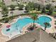 The community pool featuring a playful splash area, surrounded by lounge chairs and palm trees at 2136 Lula Rd, Minneola, FL 34715