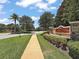 Community entrance sign and manicured landscaping, showcasing the welcoming atmosphere of the neighborhood at 2136 Lula Rd, Minneola, FL 34715