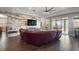 Bright living area featuring wood-look flooring, a large sectional couch, and sliding glass doors to the patio at 2136 Lula Rd, Minneola, FL 34715