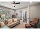 Cozy living room area featuring neutral tones, bright window, and comfortable seating at 2136 Lula Rd, Minneola, FL 34715