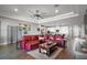 Open-concept living room boasts a red leather sofa and an adjacent modern kitchen with stainless appliances at 2136 Lula Rd, Minneola, FL 34715