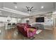 Open-concept living room features a shiplap accent wall, tray ceiling, and dark wood-look flooring at 2136 Lula Rd, Minneola, FL 34715