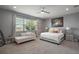 Serene main bedroom featuring a king bed, sitting area, and a large window with natural light at 2136 Lula Rd, Minneola, FL 34715