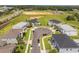 A beautiful light blue two-story home nestled in a cul-de-sac is captured in this aerial view at 2161 Cedar Springs Way, Minneola, FL 34715