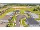 Expansive aerial view of a two-story light blue home nestled within a meticulously maintained cul-de-sac at 2161 Cedar Springs Way, Minneola, FL 34715