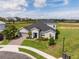Beautiful gray home featuring a well manicured lawn and a brick driveway in a desirable neighborhood at 2161 Cedar Springs Way, Minneola, FL 34715