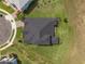 Aerial view of a home's roof, highlighting its dark shingles and overall architectural design, with the yard below at 2161 Cedar Springs Way, Minneola, FL 34715