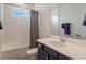 Clean bathroom showcasing a blue vanity, tub, and shower at 2161 Cedar Springs Way, Minneola, FL 34715