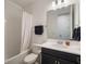 Bathroom featuring a shower-tub combo, a white tile backsplash, and a dark vanity at 2161 Cedar Springs Way, Minneola, FL 34715