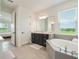 Bathroom featuring tub, vanity with storage, and tile flooring at 2161 Cedar Springs Way, Minneola, FL 34715