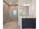 Bright bathroom featuring a glass shower and vanity with storage at 2161 Cedar Springs Way, Minneola, FL 34715