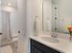 Bathroom featuring large mirror over vanity and open view to bathtub and shower at 2161 Cedar Springs Way, Minneola, FL 34715