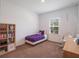 Cozy bedroom with comfortable bed, storage, and natural light from window at 2161 Cedar Springs Way, Minneola, FL 34715