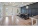 Elegant dining area featuring stylish lighting, a dark accent wall, and wood-look flooring at 2161 Cedar Springs Way, Minneola, FL 34715