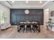 Elegant dining area featuring stylish lighting, a dark accent wall, and wood-look flooring at 2161 Cedar Springs Way, Minneola, FL 34715