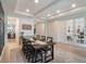 Bright dining room featuring coffered ceilings and a long table for eight, perfect for Gathering gatherings and entertaining at 2161 Cedar Springs Way, Minneola, FL 34715