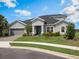 Charming one-story home with manicured front lawn, paver driveway, and an attached two-car garage at 2161 Cedar Springs Way, Minneola, FL 34715