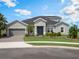 Charming one-story home with manicured front lawn, paver driveway, and an attached two-car garage at 2161 Cedar Springs Way, Minneola, FL 34715