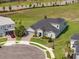 A beautiful light blue two-story home with a well-manicured lawn and a paved driveway is shown at 2161 Cedar Springs Way, Minneola, FL 34715