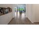 Bright hallway with wood flooring offers a seamless transition into a living area with natural light at 2161 Cedar Springs Way, Minneola, FL 34715