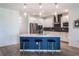 Stylish kitchen featuring a center island with seating, stainless steel appliances and modern lighting for cooking and entertaining at 2161 Cedar Springs Way, Minneola, FL 34715