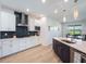 Bright kitchen with a breakfast bar, sleek countertops, stainless steel appliances, and stylish backsplash for cooking at 2161 Cedar Springs Way, Minneola, FL 34715