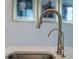 A modern kitchen sink featuring a sleek, brushed nickel faucet and filtration system at 2161 Cedar Springs Way, Minneola, FL 34715