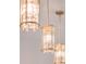 Close-up of the designer lighting fixture showcasing intricate details and casting a warm glow in this modern home at 2161 Cedar Springs Way, Minneola, FL 34715