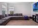 Relaxing living room featuring a large sectional sofa, big-screen TV, and neutral carpet at 2161 Cedar Springs Way, Minneola, FL 34715