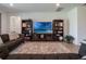 Comfortable living area with TV, decor, and light hardwood floors at 2161 Cedar Springs Way, Minneola, FL 34715