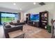 Comfortable living area with plush sofa, large windows, and view at 2161 Cedar Springs Way, Minneola, FL 34715