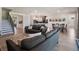 Bright, open-concept living room featuring hardwood floors and views into kitchen and dining areas at 2161 Cedar Springs Way, Minneola, FL 34715