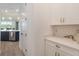 Convenient pantry with ample storage space and countertop, enhancing organization in this home at 2161 Cedar Springs Way, Minneola, FL 34715