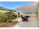 Scenic backyard with a covered patio, mature landscaping, and an inviting outdoor space at 2465 Violet Ct, The Villages, FL 32162